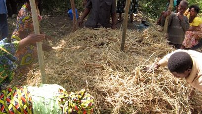 Layering materials to make a compost pile.