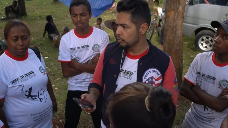 A Hispanic male interviews and records Malagasy colleagues
