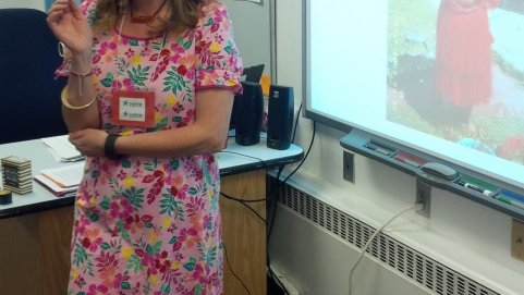 Laura wears a muumuu and explains Palauan first childbirth ceremony to fifth graders.
