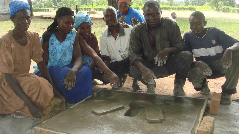 Uganda: Volunteer health team with the completed cement pit latrine.