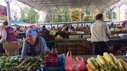 A woman selling her produce at the bazaar.
