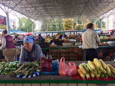 A woman selling her produce at the bazaar.